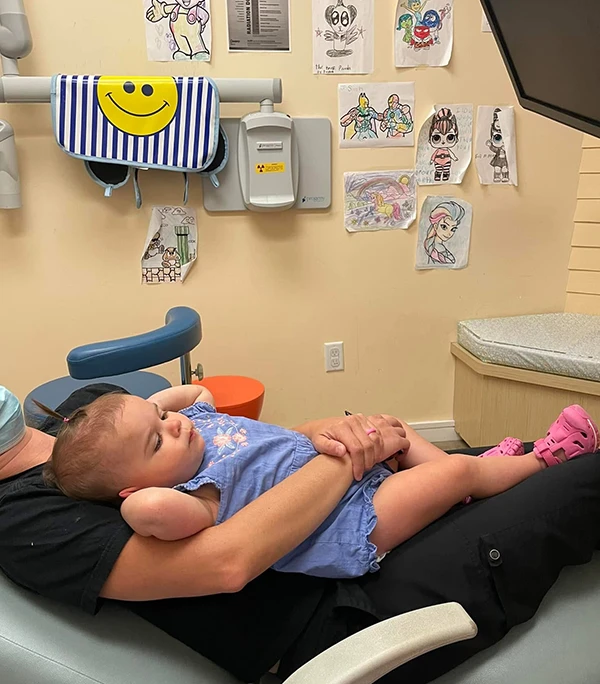 An infant on their parent's lap during first visit